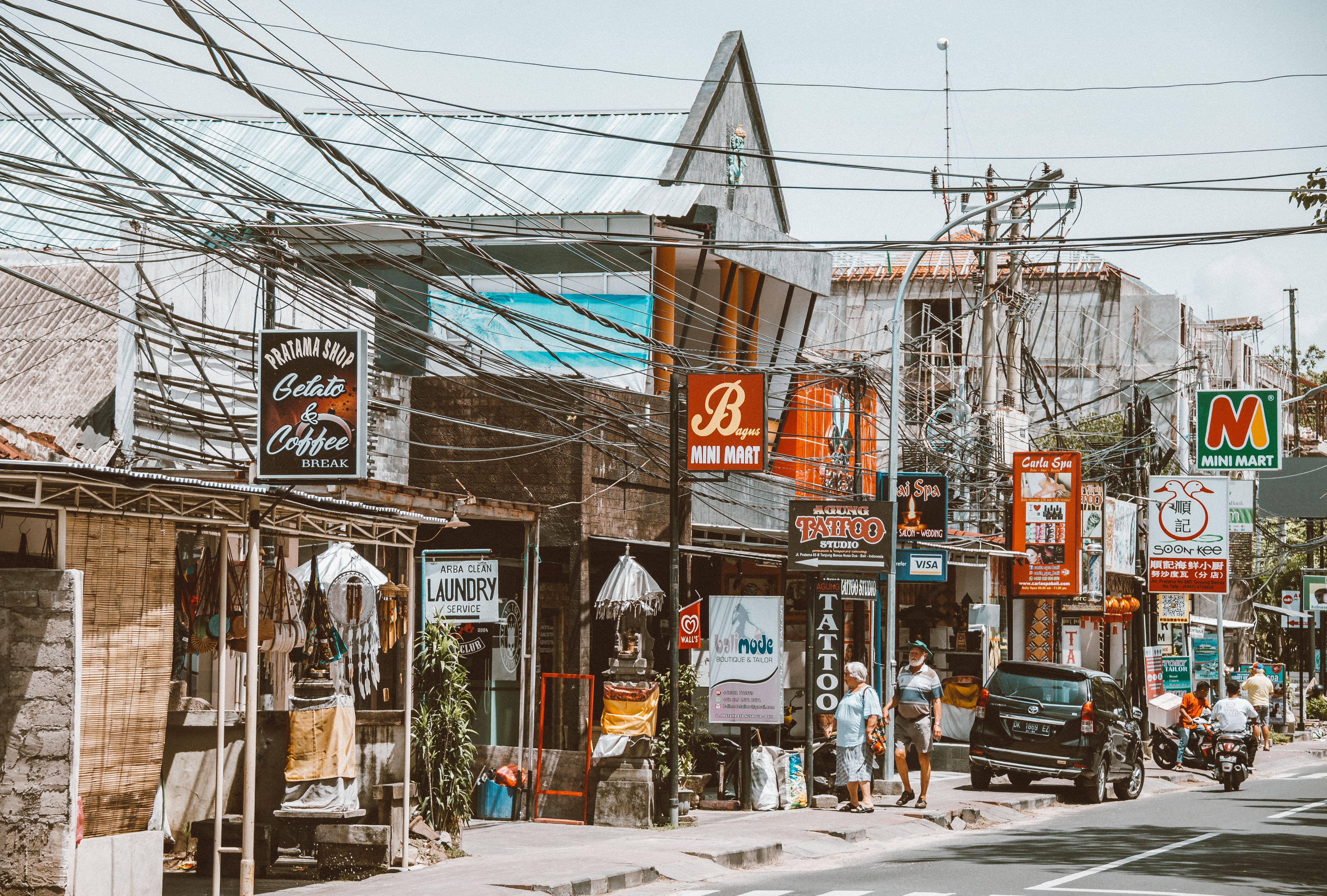 Pedestrian street on Jalan Batu Bolong Canggu with cafes and tropical palm trees