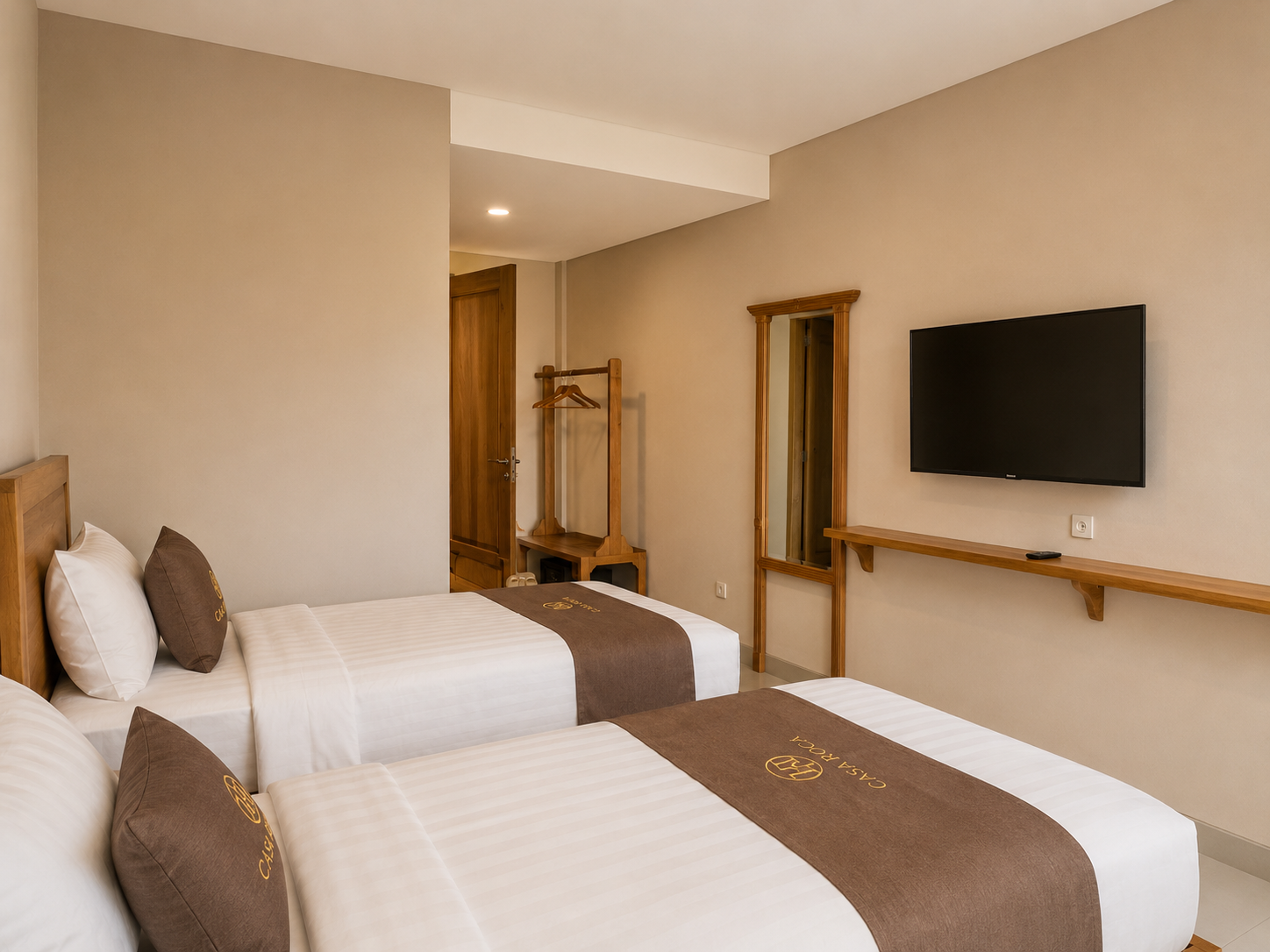 Superior Room at Casa Roca Canggu - teak wood furniture and private balcony